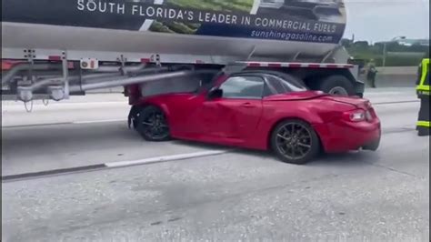 Miata ends up wedged under fuel tanker on I-95 in Miami, causing lane closures